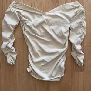 KHAITE Cream Off-Shoulder Blouse